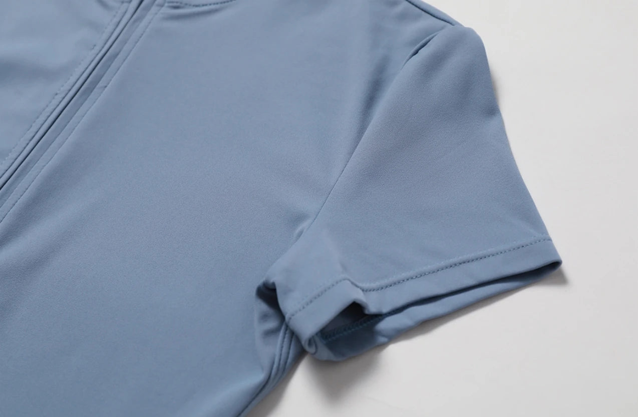Blue athletic shirt with a zipper on a light gray background