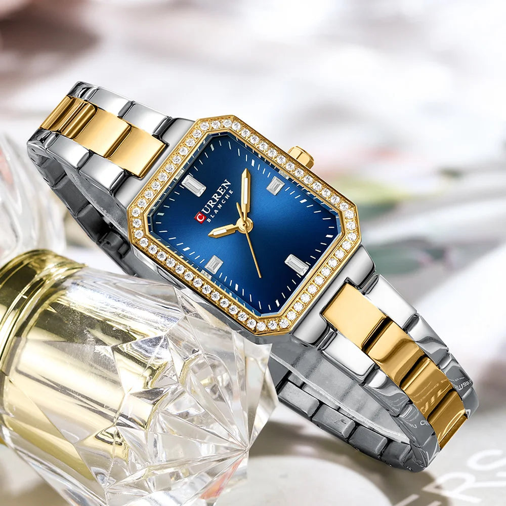 Luxury watch with blue face and gold accents on a blurred background