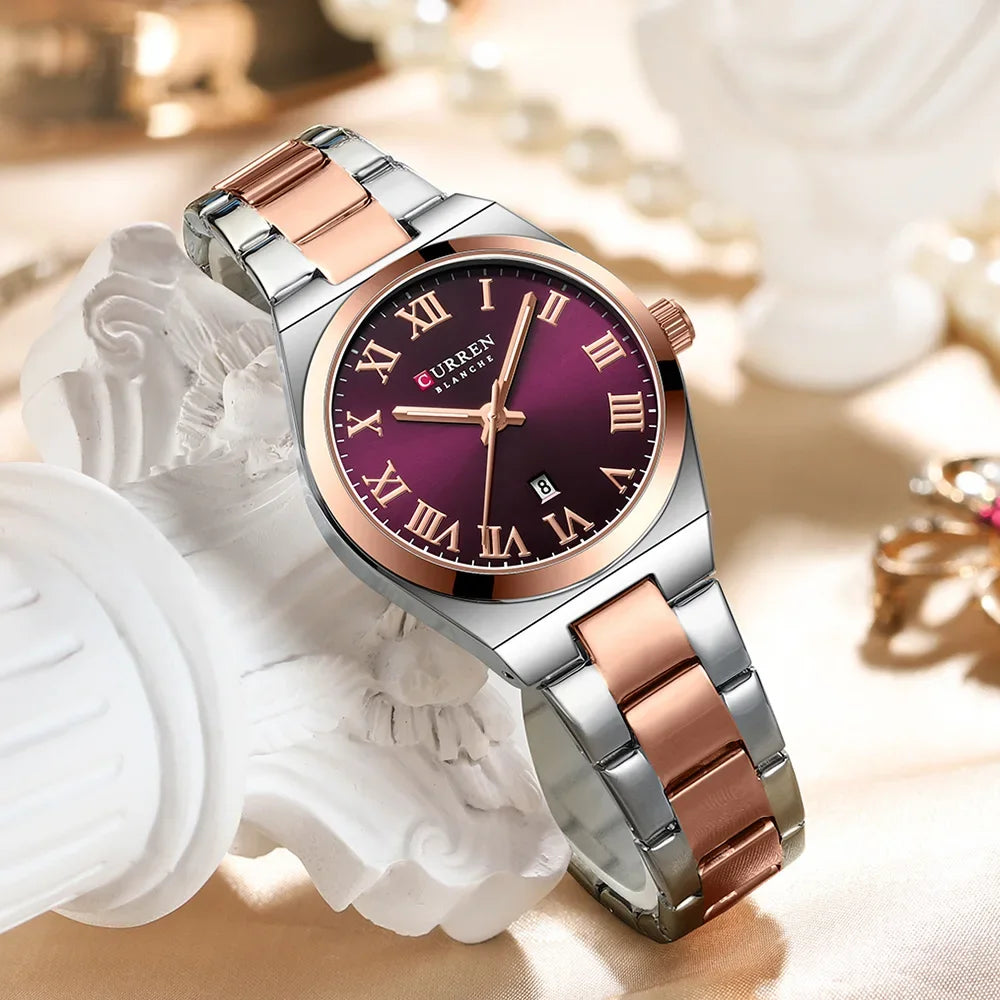 Silver and rose gold watch with a purple face on a decorative background