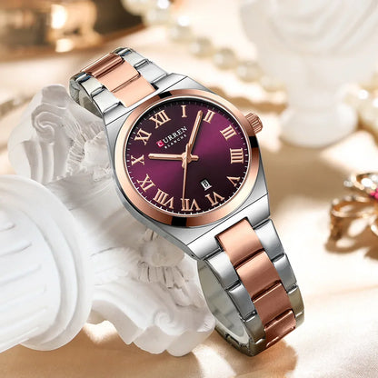 Silver and rose gold watch with a purple face on a decorative background
