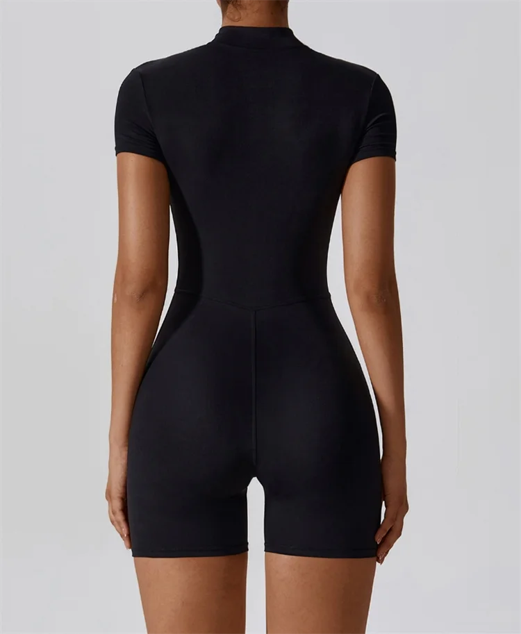 Black bodysuit worn by a person on a plain background