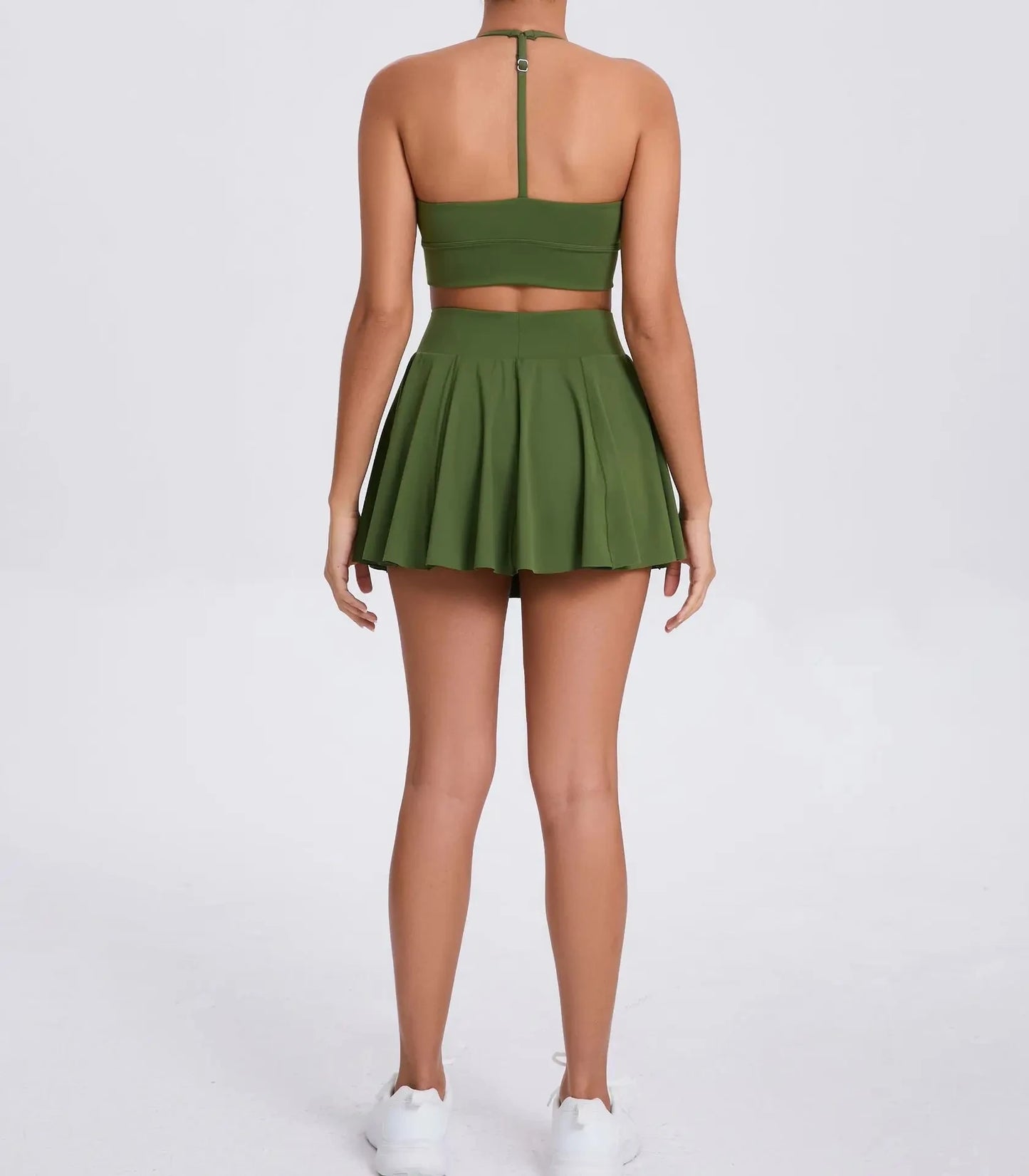 Green two-piece outfit with a skirt and top on a white background