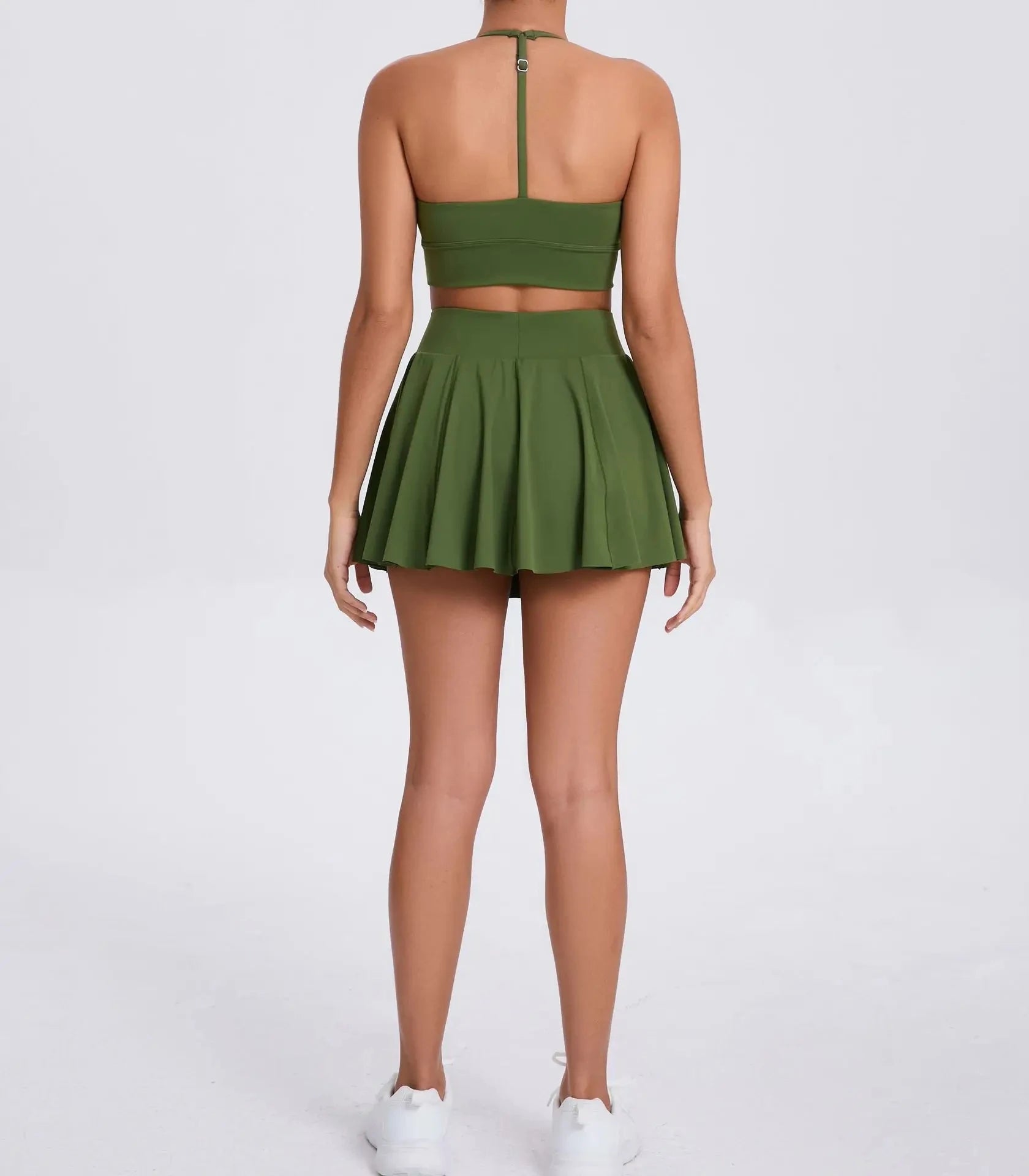 Green two-piece outfit with a skirt and top on a white background