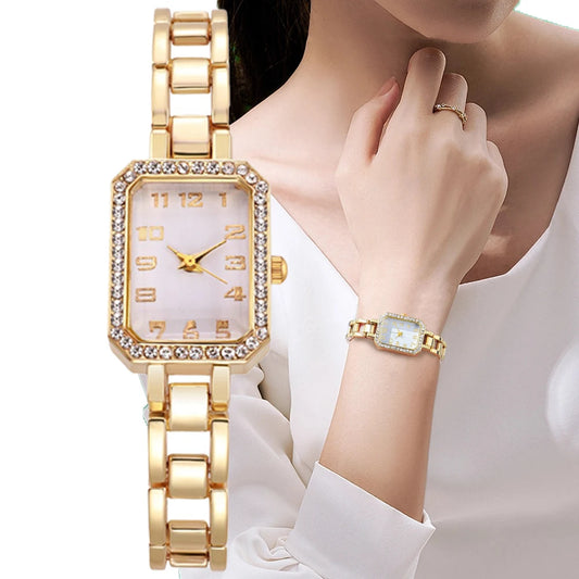 Gold wristwatch and bracelet on a mannequin with a white background