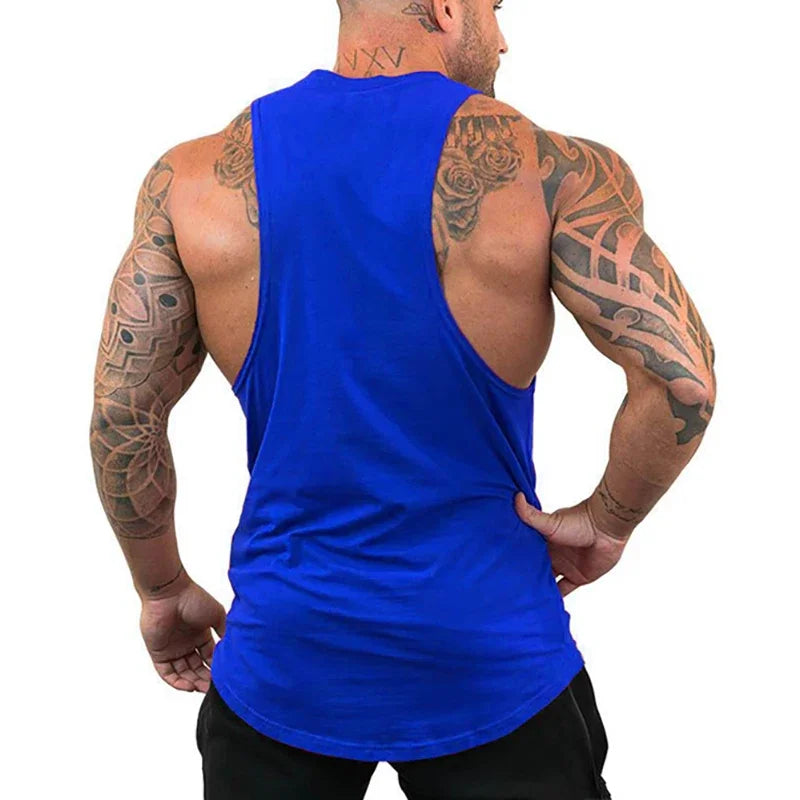 Man wearing a blue tank top with visible tattoos on a white background