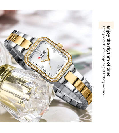 Gold and silver watch with diamond accents on a white background