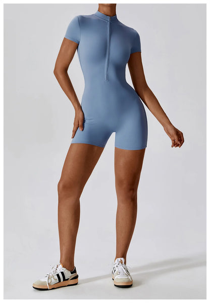 Person wearing a blue bodysuit on a light gray background