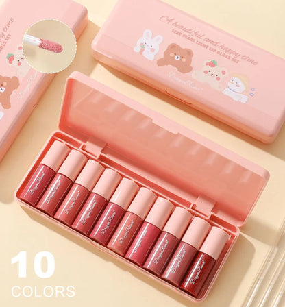 Set of 10 lip glosses in a pink case with cartoon designs on a light yellow background.