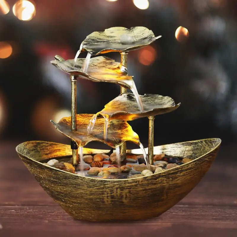 Decorative indoor water fountain with leaf design on a blurred background