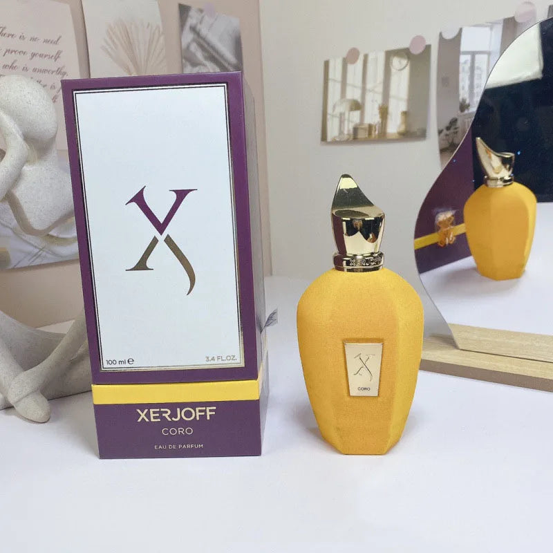 Yellow Xerjoff perfume bottle with packaging on a white surface