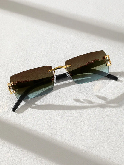 Sunglasses with gold frames and rectangular lenses on a light background