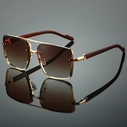 Sunglasses with gold frame and brown lenses on a reflective surface
