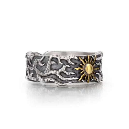 Silver ring with sun design on a white background