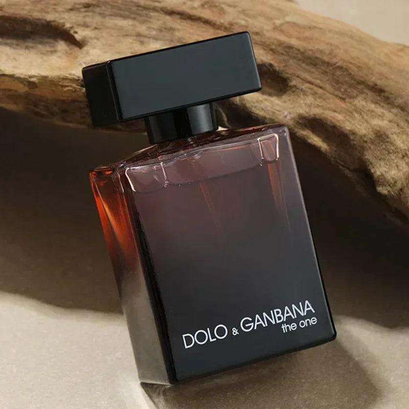 Perfume bottle labeled 'DOLO & GANBANA the one' on a textured surface