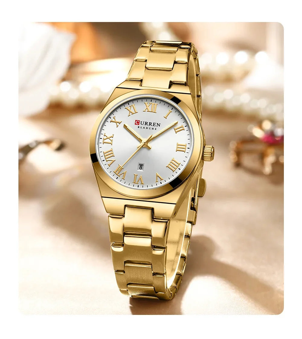 Gold wristwatch with a white face and Roman numerals on a blurred background