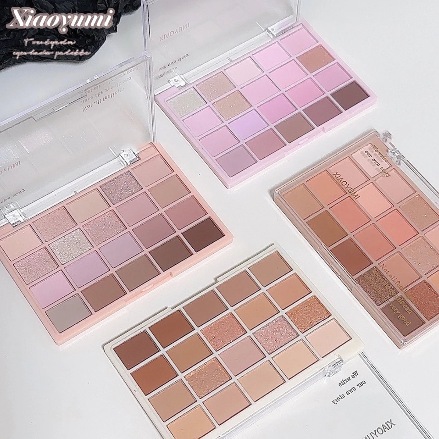 Four makeup palettes with various shades of pink, brown, and beige on a white background. Brand 'Xiaoyumi' is visible.