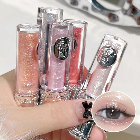 Set of lip glosses with a close-up of a glittery eye color.