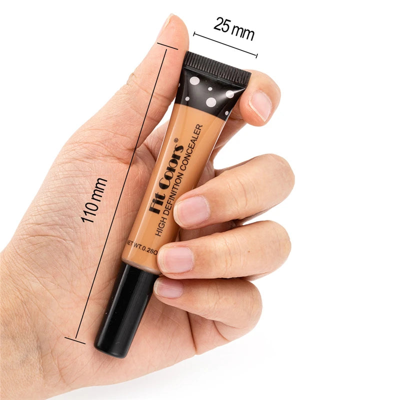 Hand holding a concealer stick with measurements on a white background