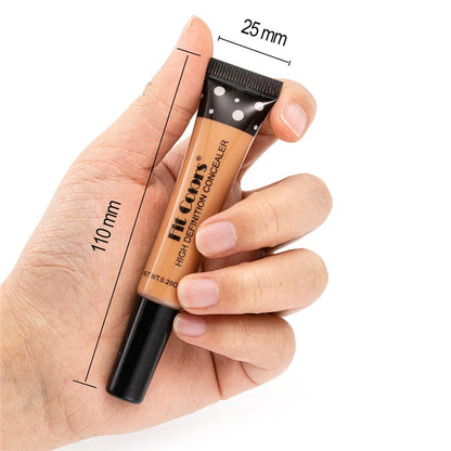 Hand holding a concealer stick with measurements on a white background
