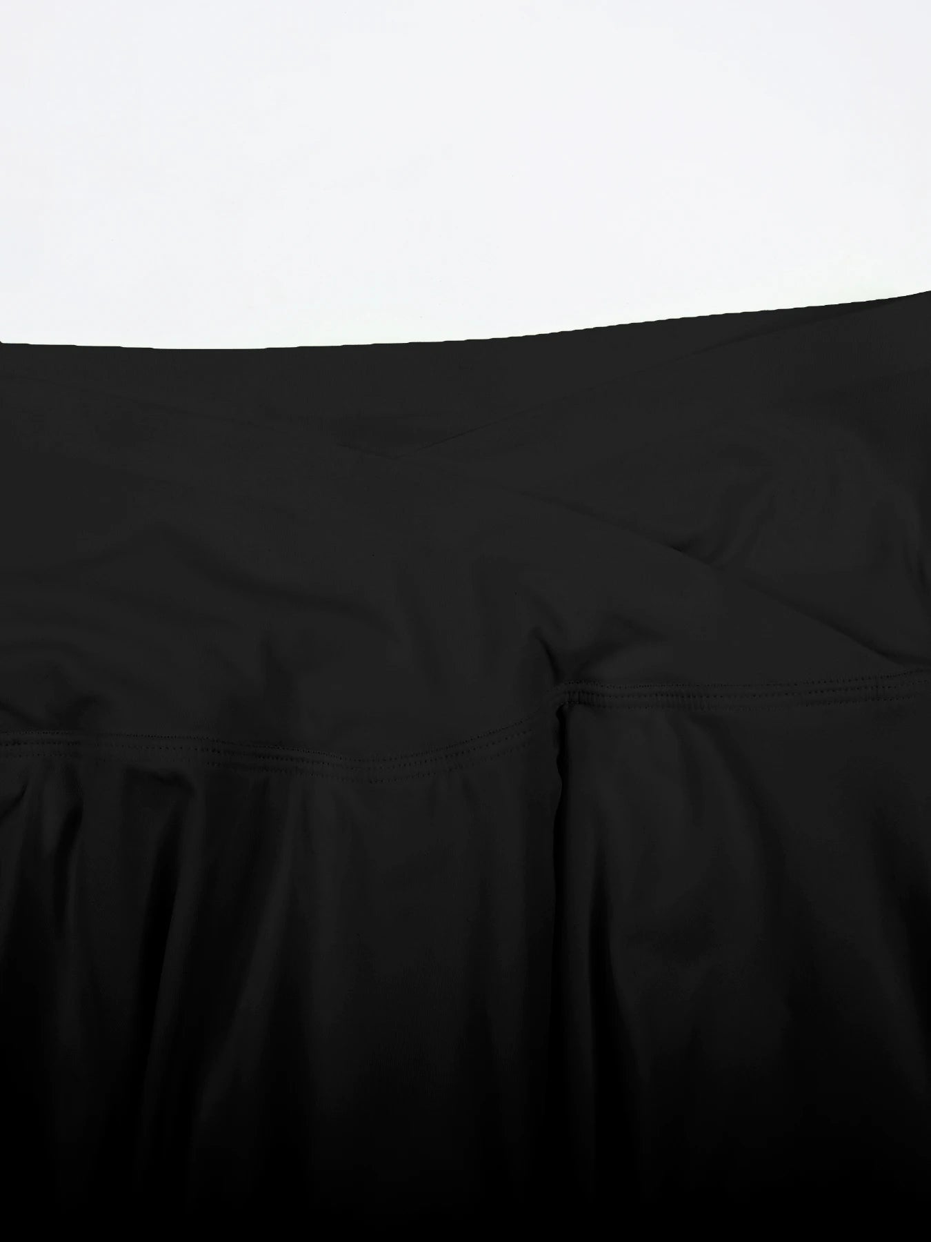 Close-up of a black comforter on a bed