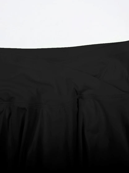 Close-up of a black comforter on a bed