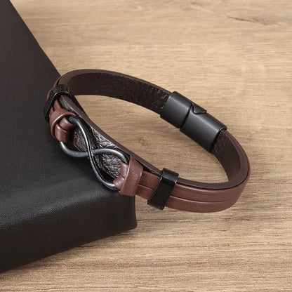 Brown leather bracelet with a black clasp on a wooden surface