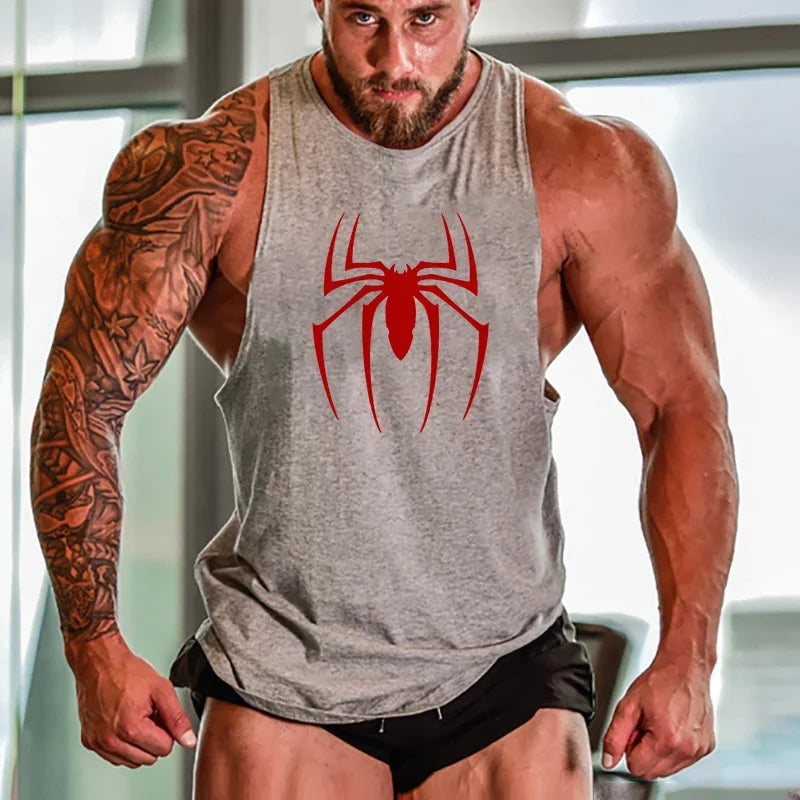Muscular person wearing a gray tank top with a red spider logo.