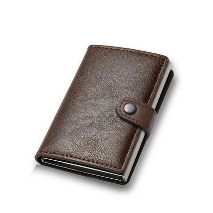 Brown leather wallet with a metallic button on a white background
