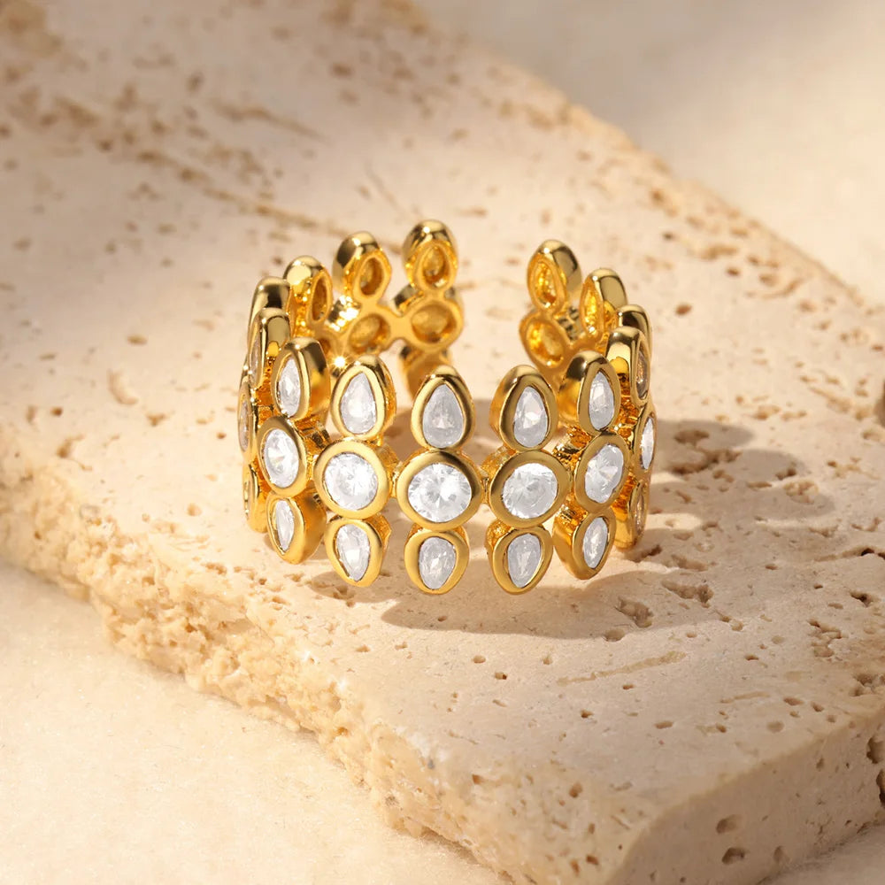 Gold and white beaded bracelet on a textured beige surface
