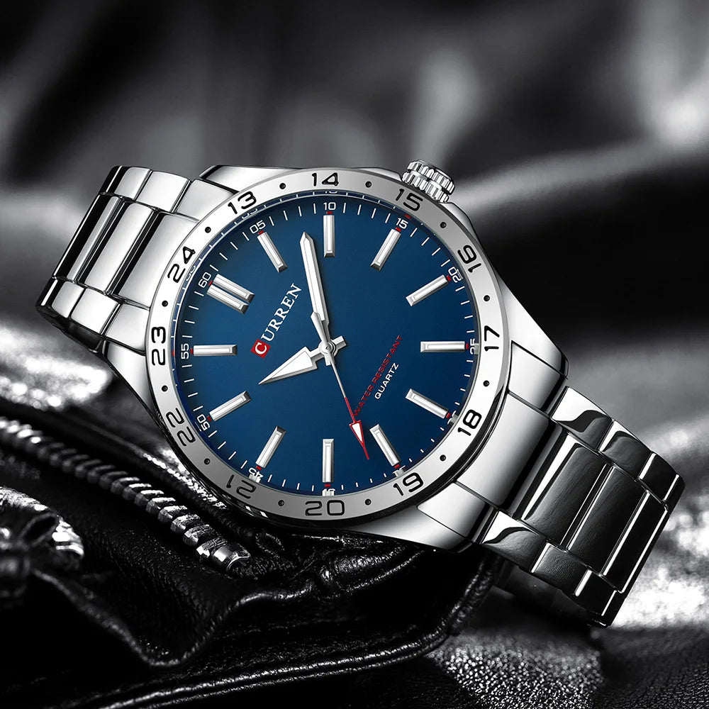 Silver watch with blue dial on a textured surface