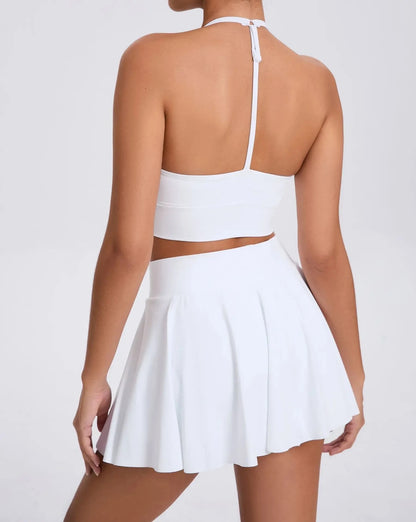 White two-piece outfit with a skirt and top on a plain background