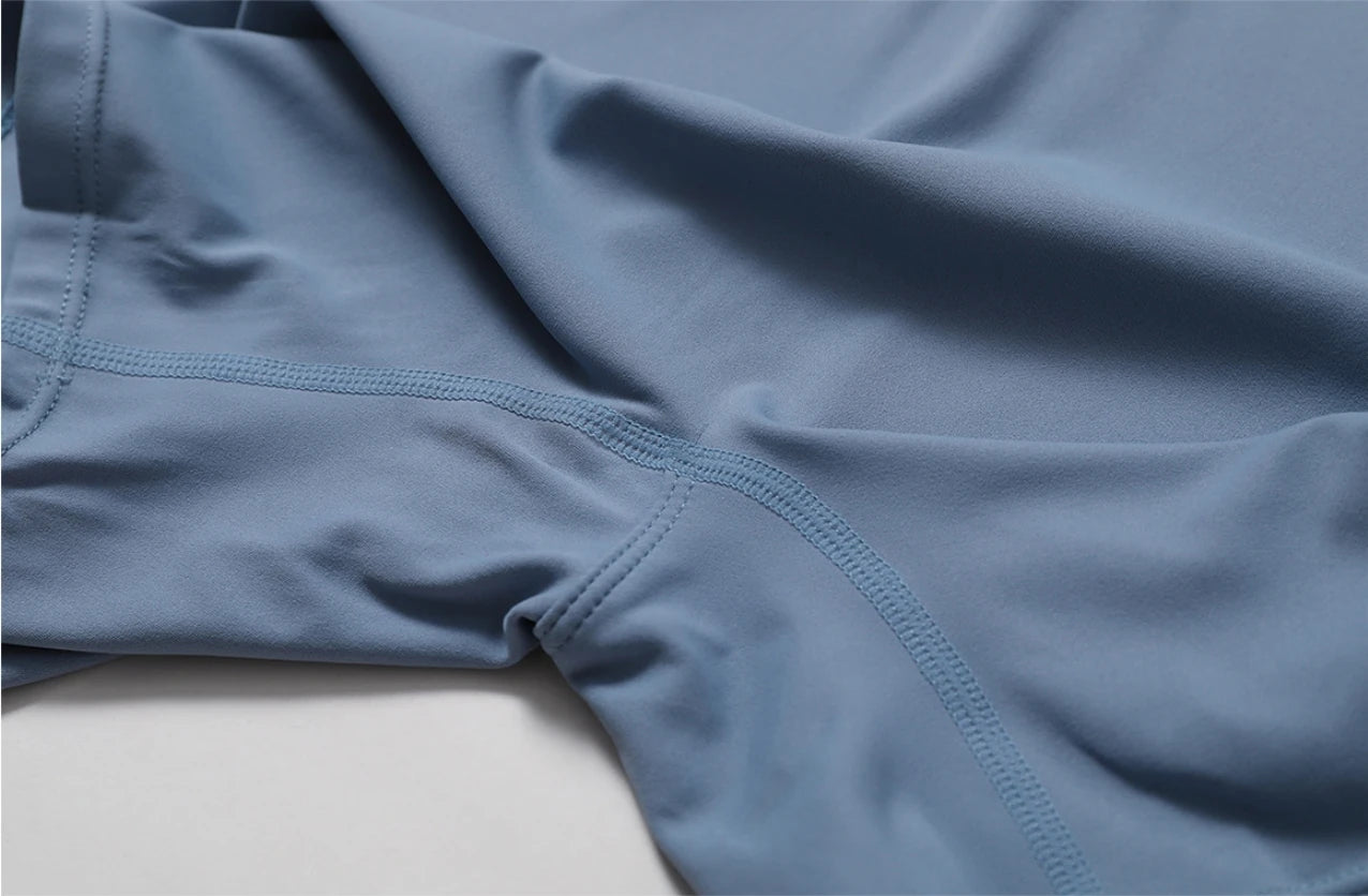 Close-up of blue athletic shorts on a light gray background