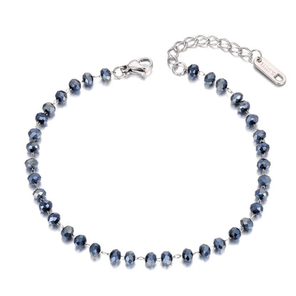 Silver bracelet with blue beads on a white background