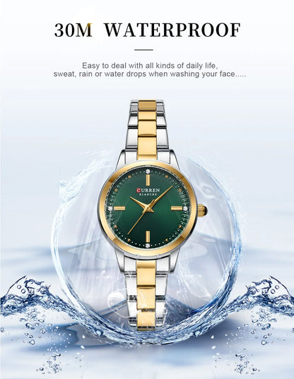 Gold and silver watch with green face on a white background