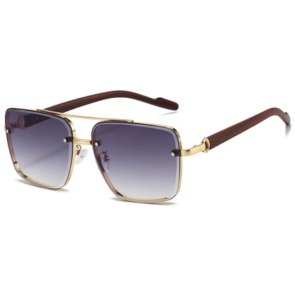 Sunglasses with gold frame and brown arms on a white background