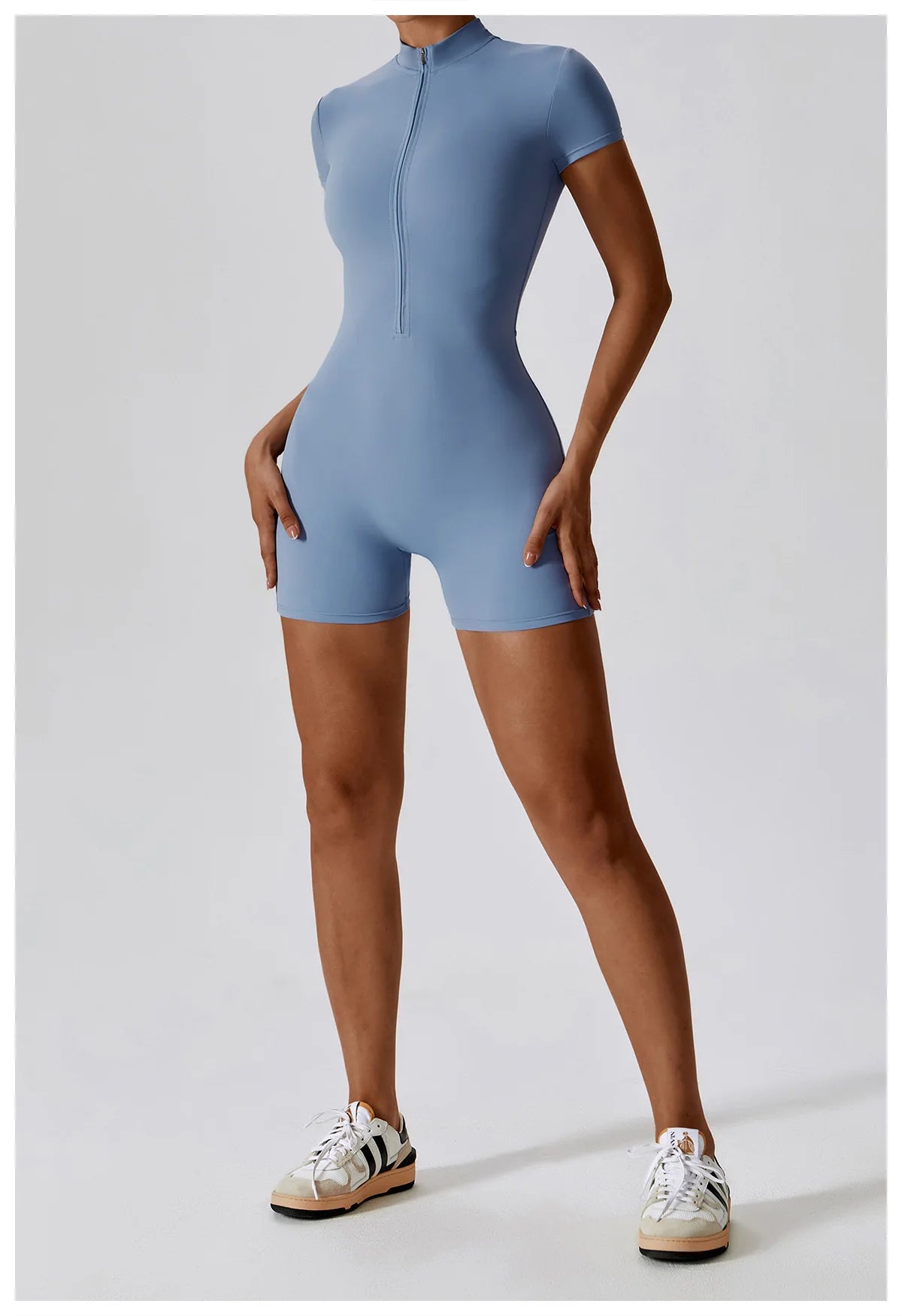 Person wearing a blue bodysuit on a white background