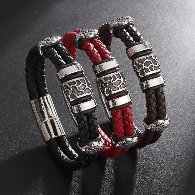 Three braided leather bracelets with silver metal clasps on a dark background