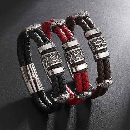 Three braided leather bracelets with silver metal clasps on a dark background