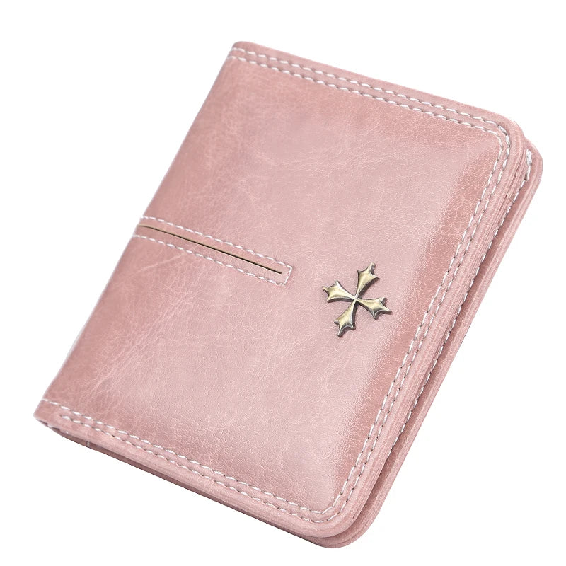 Pink wallet with a cross emblem on a white background