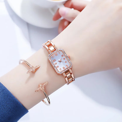 Rose gold watch on a wrist with a blurred background