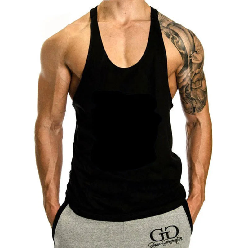 Person wearing a black tank top and gray shorts with a visible brand logo on a white background
