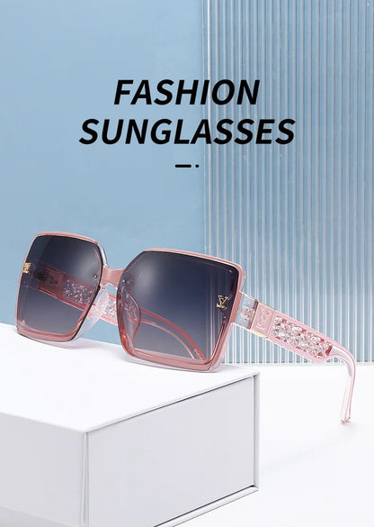Fashion sunglasses with pink frame and dark lenses on a white surface with blue background