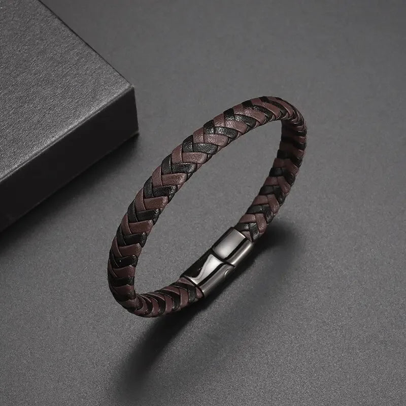 Woven leather bracelet with metallic clasp on a gray background