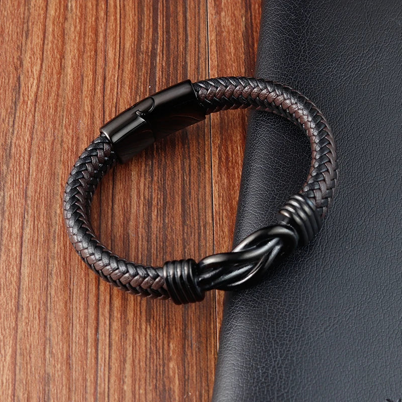 Black braided leather bracelet on a wooden surface