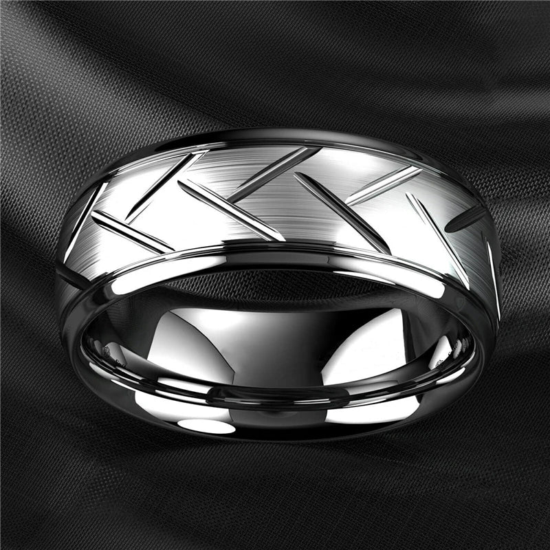 Silver ring with geometric design on a black background