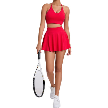 Person wearing a red tennis outfit holding a racket on a white background