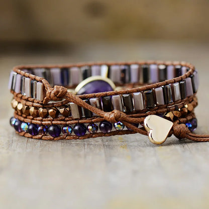 Multistrand bracelet with beads and heart charm on a wooden surface