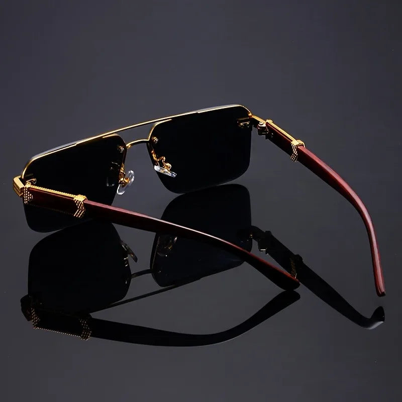 Sunglasses with gold frame and red arms on a reflective black surface