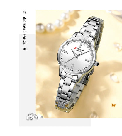 Silver wristwatch with a white face on a decorative background