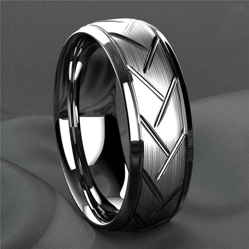Silver ring with geometric design on a gray background